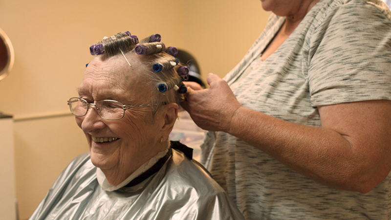Friendly faces getting hair done in our skilled nursing home amenities