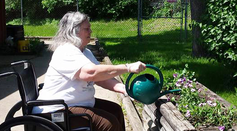 Resident tends to plants at our long term care home