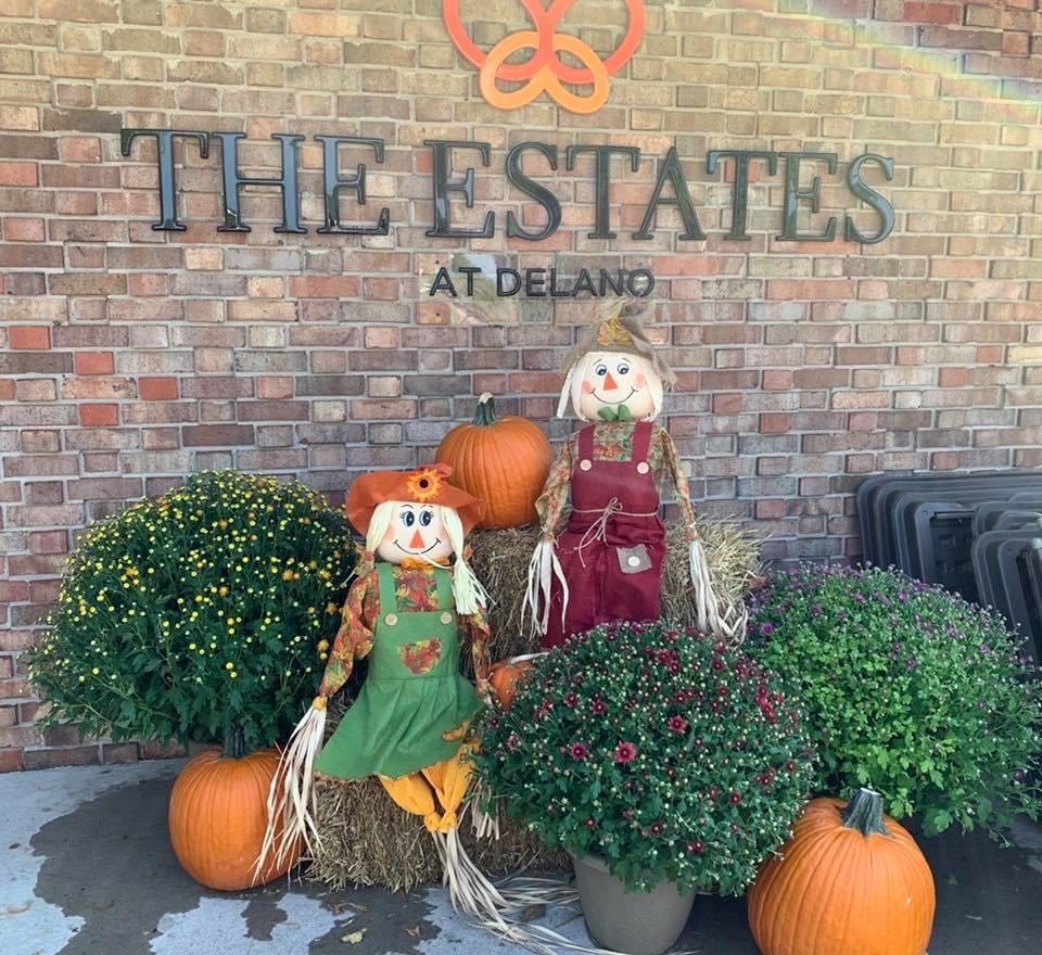 Entrance sign with scarecrows and pumpkins