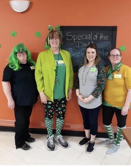 4 staff members dressed in green for Saint Patrick's Day